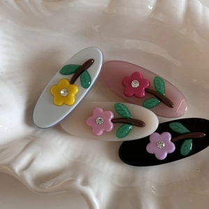 Set of four jelly color rhinestone flower hair clips for girls in pink, blue, white, and black