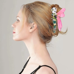 Vintage dragonfly hair claw clip with acetate wings shown on a woman hairstyle