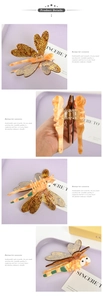 Detailed view of a dragonfly hair claw clip with acetate finish and marble texture