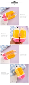 Close-up of pencil-shaped hair claw clip with yellow and pink colors and metal spring