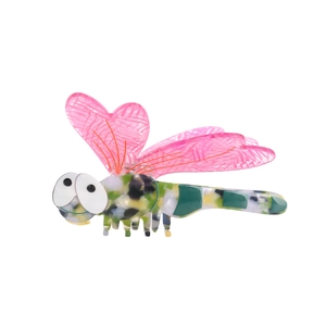 Vintage acetate dragonfly hair claw clip with pink wings and green marbled body on white