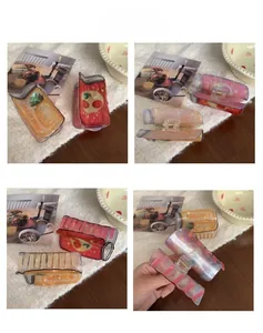 Detailed views of iridescent juice can hair claws with pineapple and cherry designs