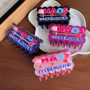Set of four shimmering acrylic hair claws with heart arrows and chaos coordinator text
