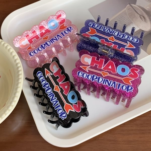 Set of four acrylic hair claw clips with glitter finish and Chaos Coordinator text