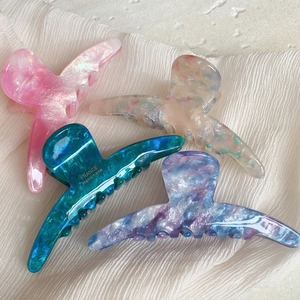 Elegant tortoiseshell acetate hair claws in assorted marble patterns and vibrant colors