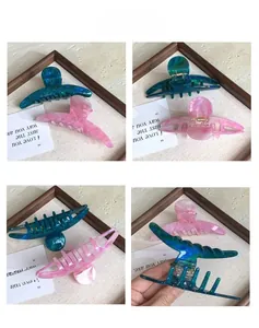 Detailed views of marble pattern acetate hair claws showing textures and spring mechanisms