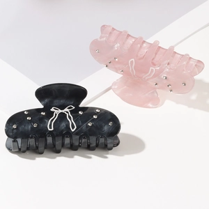 Elegant set of black marble and translucent pink bow hair claws with sparkling rhinestones