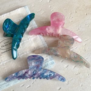 Set of four elegant acetate shark hair clips in marble and gradient ocean colors