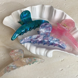 Elegant acetate shark hair claws in marble textures including teal, purple, pink and white