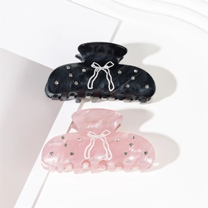 Elegant acetate bow hair claws with rhinestones in black and light pink colors