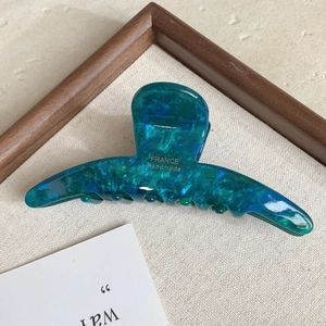 Close-up of green marble pattern acetate hair claw with gold France Handmade lettering