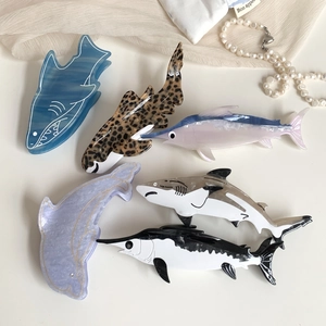 Assorted ocean themed acetate hair claws featuring shark and dolphin designs in various patterns