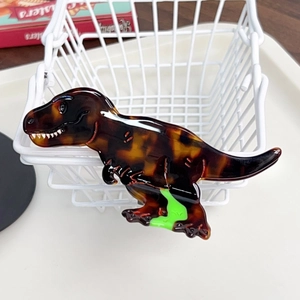 Detailed close-up of a dinosaur shark hair clip made from tortoiseshell acetate material