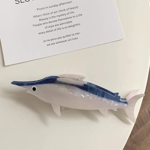Close-up of a realistic blue swordfish hair claw clip made of acetate with translucent belly