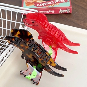 Cartoon dinosaur hair claw clips in vibrant red and tortoise shell acetate finish
