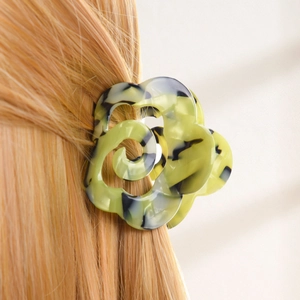 Floral acetate hair claw clip with marble texture shown on blonde hair