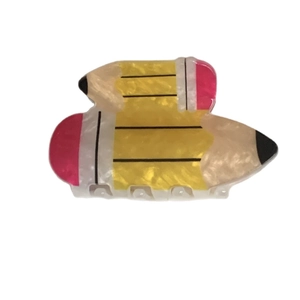 Creative yellow pencil shaped acrylic hair claw clip for ponytail styling on white background