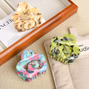 Three-piece set of acetate hair claw clips with hollow spiral design in marble patterns