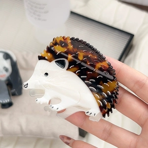 Close-up of a hedgehog-shaped acetic acid hair claw with brown tortoiseshell texture