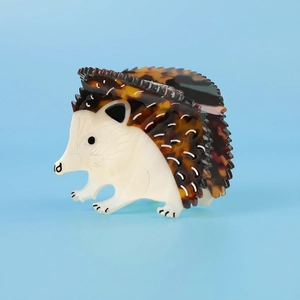 Detail shot of a hedgehog-shaped acetate hair claw featuring tortoiseshell patterns
