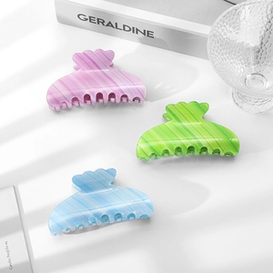 Three gradient candy-colored acetate hair claws with striped texture and wavy design