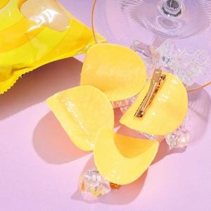 Detailed view of realistic yellow potato chip hair clips with metal duckbill back clips