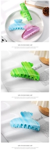 Detailed macro view of jelly-colored hair claws in gradient green, blue and purple tones
