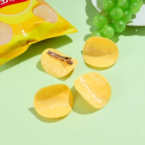Creative realistic potato chip hair clips in bright yellow on a fresh green background