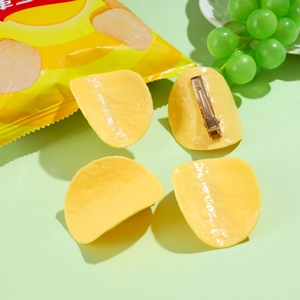 Detail view of creative potato chip hair clip set with golden metal alligator clip