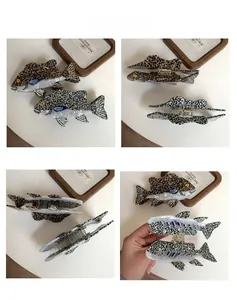 Detailed views of fish-shaped acetate hair claws with leopard and spotted patterns