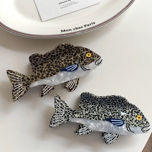 Elegant fish-shaped acetate hair claw clips with tortoiseshell and stone patterns