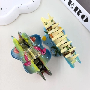 Marine themed ocean hair claw clips with colorful fish and sea horse patterns on cream base