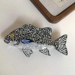 Elegant ocean fish hair claw clip made of acetate with black and white spots on white background