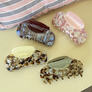 Set of four tortoiseshell acetate hair claws in pink, blue, beige, and leopard patterns