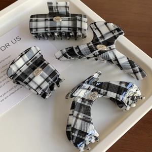 Classic black and white checkered acetate hair claw clips set in four elegant styles
