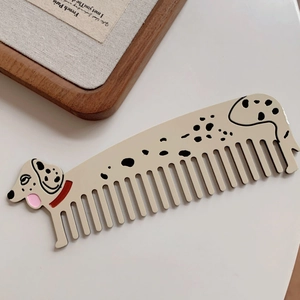 Detail view of Dalmatian dog hair claw clip with black spots and red collar accent