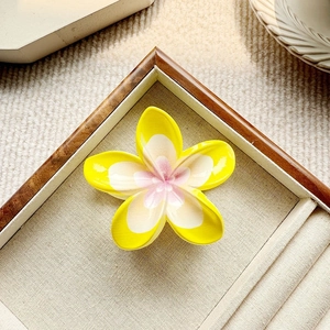 Tropische Frangipani-Haarklammer mit gelben Blütenblättern und sommerlichem Design