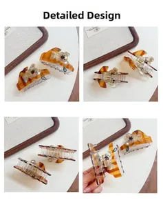 Detailed views of amber tortoise shell koala hair claw clip with green leaf accents