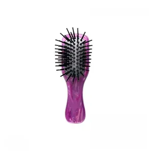 Detailed macro view of acetate hair comb with marble texture and soft air cushion