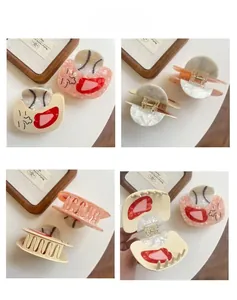 Detail view of acetate shark hair claw clips with baseball motif and marble texture