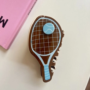 Detail of tennis racket hair claw clip in dark brown acetate with blue tennis ball deco
