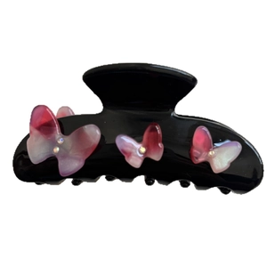 Elegant black hair claw clip featuring three pink gradient rhinestones butterflies