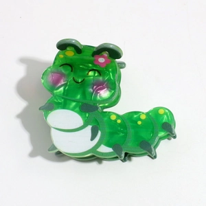 Detailed view of a green translucent caterpillar hair claw clip with pearlescent finish