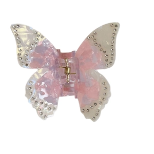 Pince à cheveux papillon en acétate marbré rose avec strass et ressort en métal doré