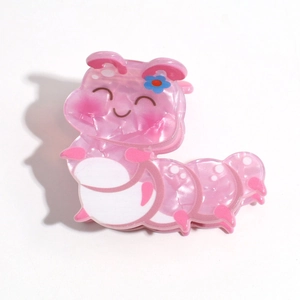 Detailed view of a pink acetate caterpillar hair claw clip with floral accent
