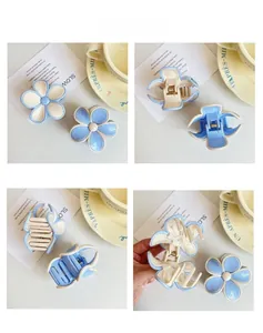 Detailed views of dual-tone blue and white flower hair claw clips with spring mechanism