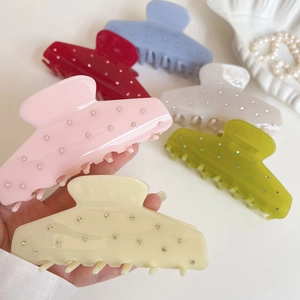 Elegant shell-shaped acetate hair claws with sparkling rhinestones in assorted colors