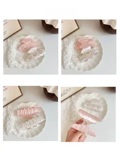 Detailed views of heart-shaped acetate hair claws with sparkling rhinestone accents