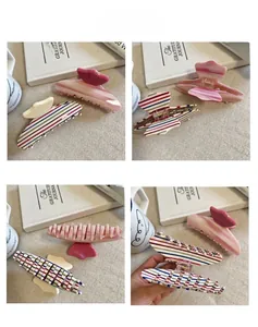 Detail view of colorful striped and pink marble acetate hair claws with sturdy metal springs