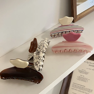 Set of four large acetate hair claws with various striped and tortoiseshell patterns